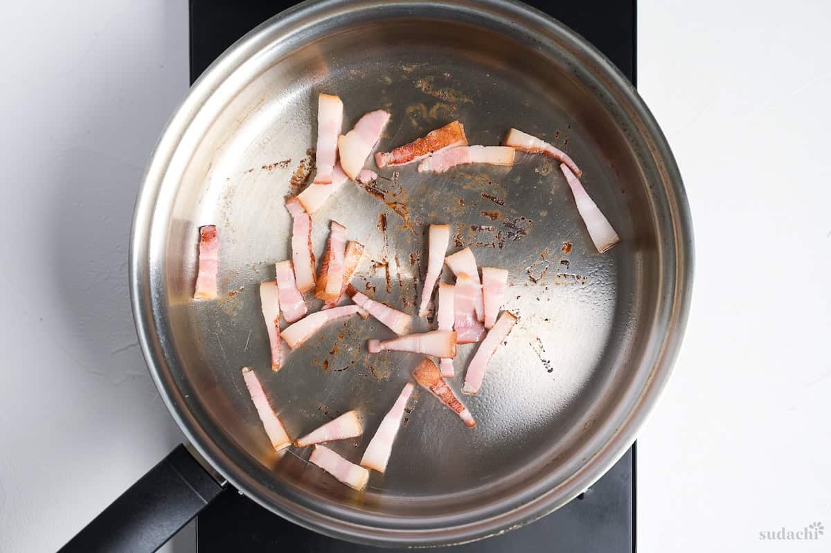Searing bacon in a pan on the stove top