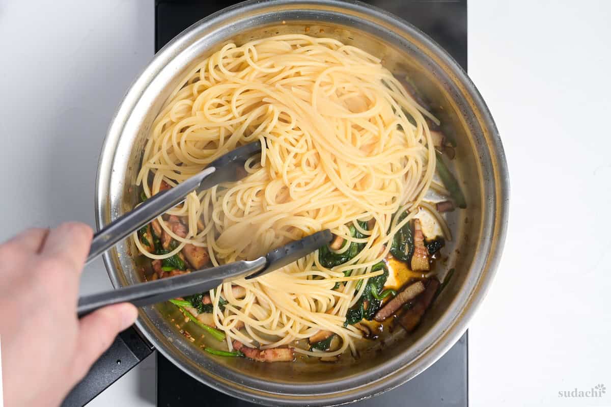 Cooked spaghetti added to pan to make wafu pasta