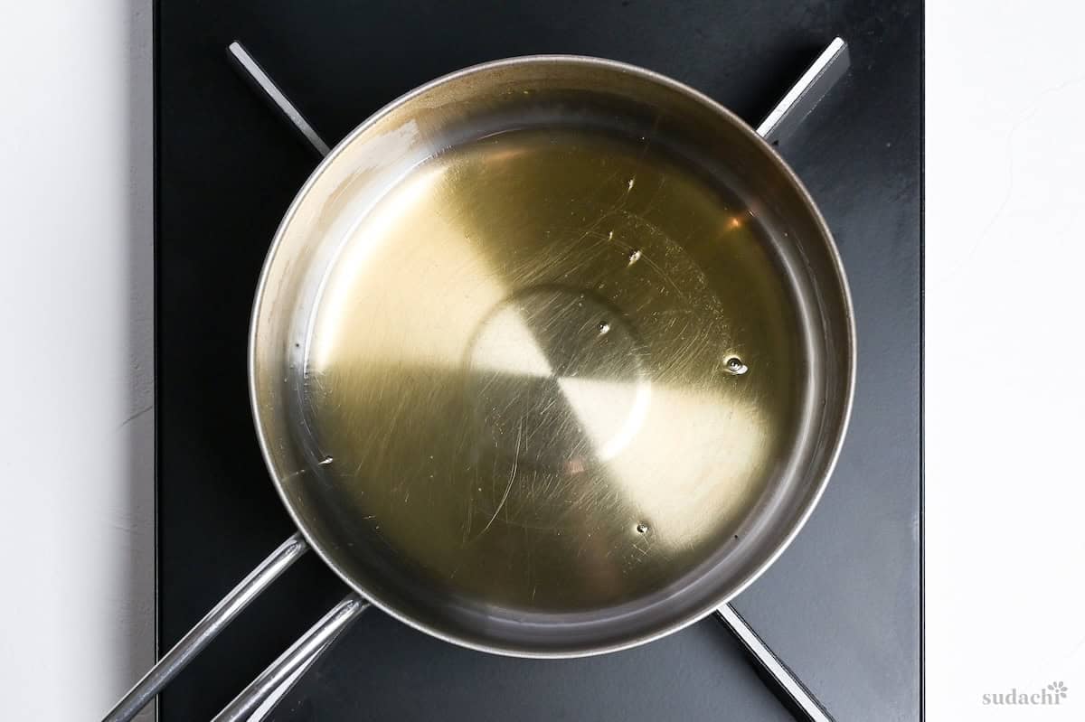 heating sugar and mirin in a pot on the stove top