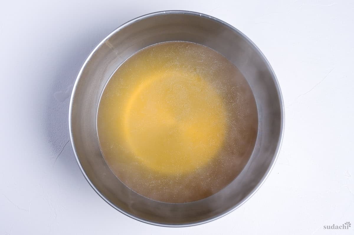 broth base for shoyu ramen in a steel mixing bowl