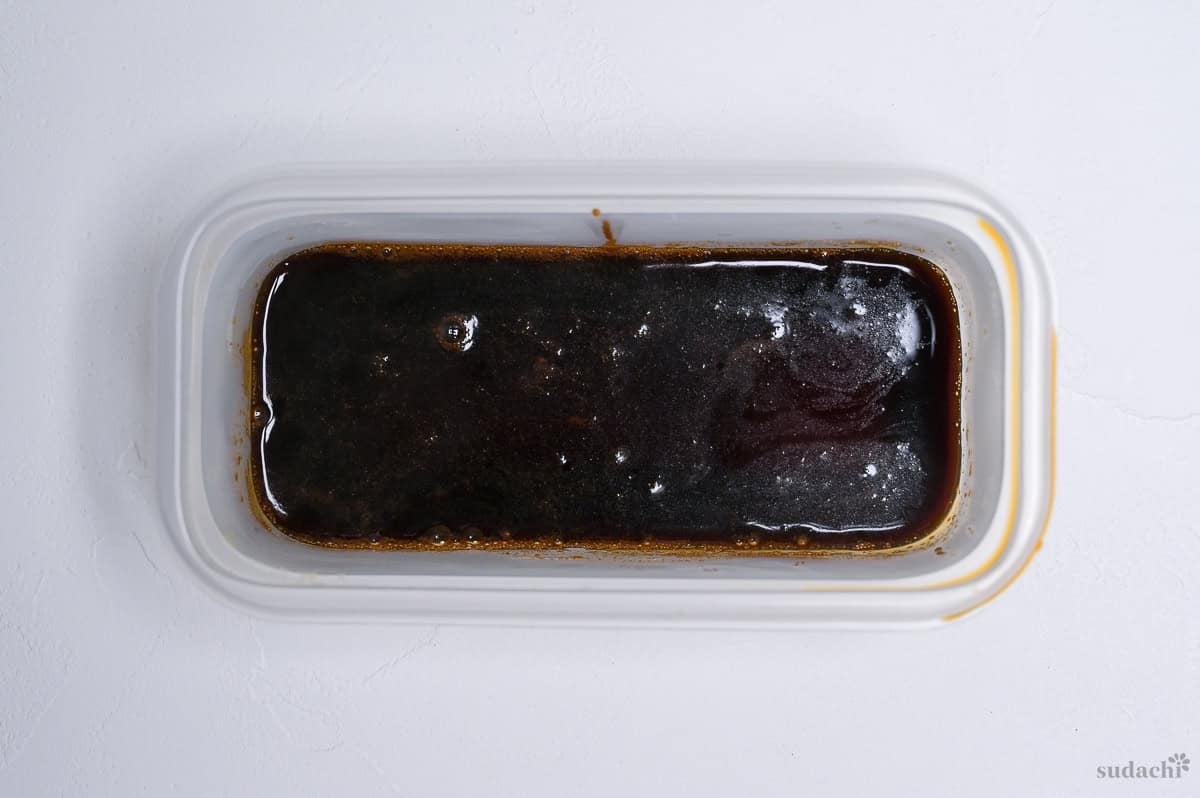 reduced shoyu ramen tare in a plastic container ready for storage