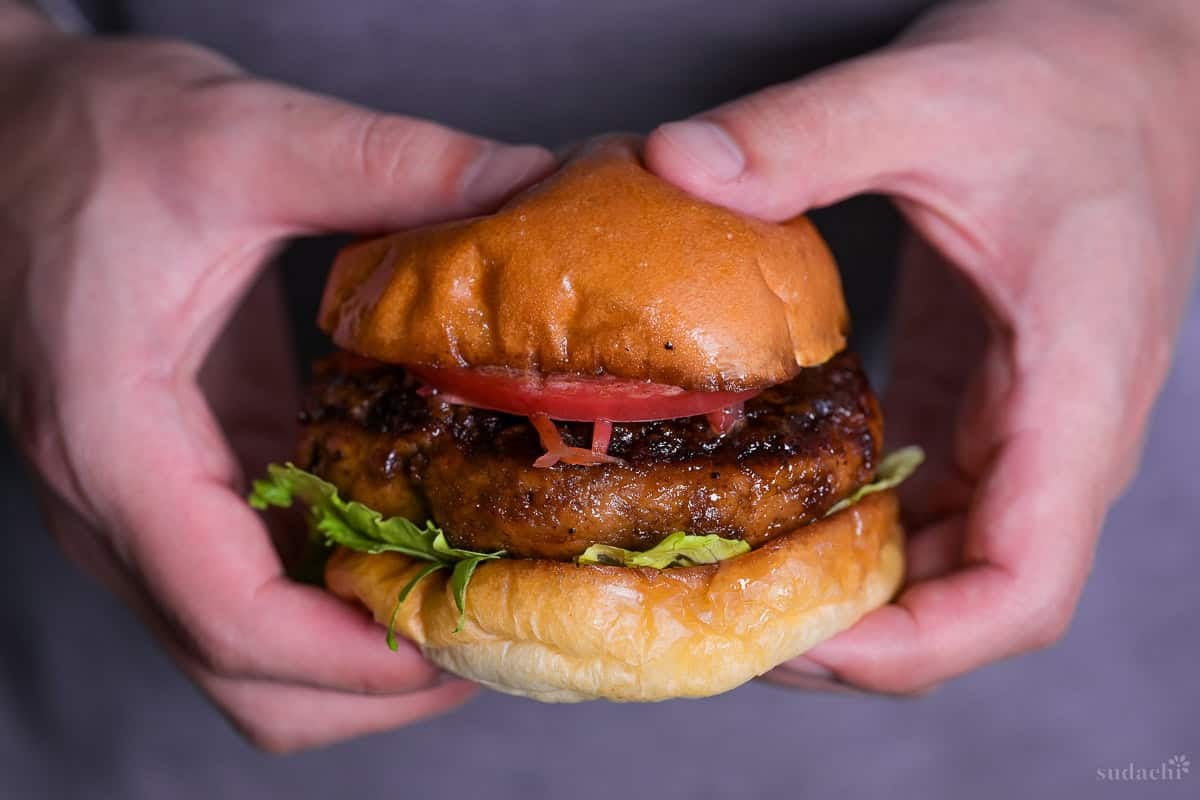 Yuto Omura holding up a teriyaki burger