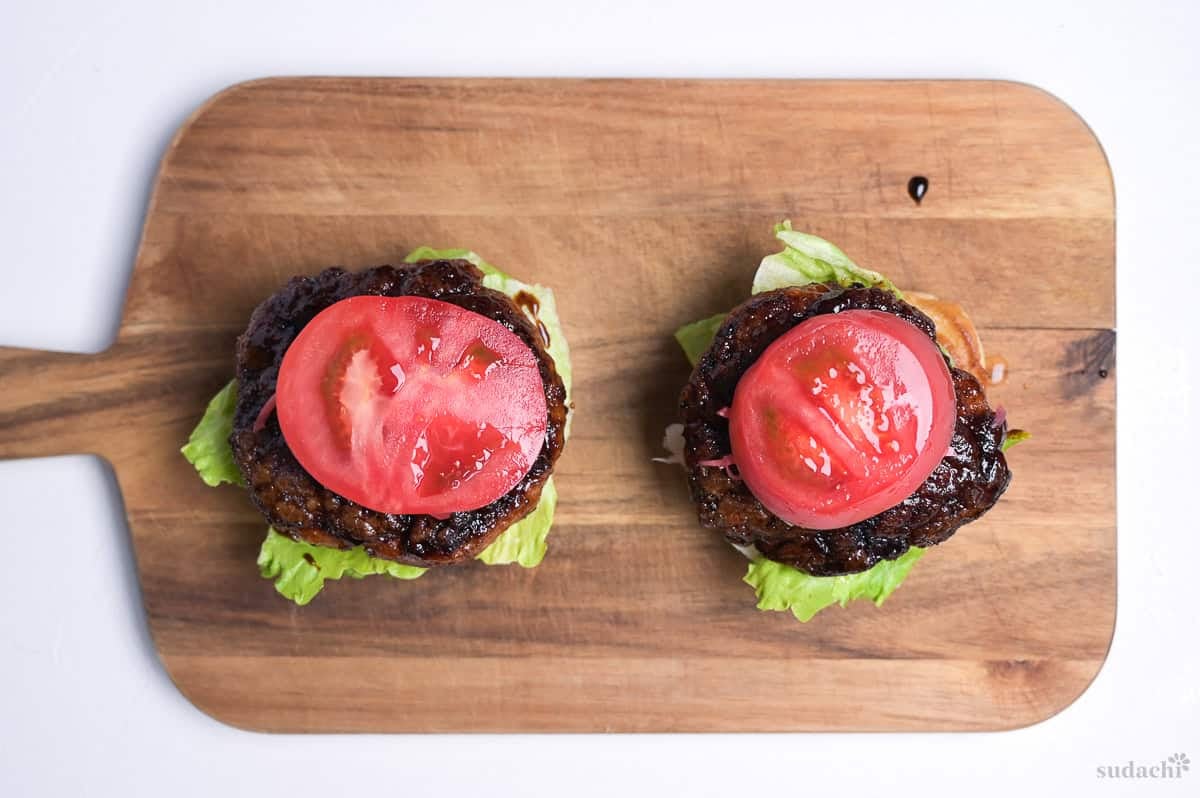 teriyaki pork patties topped with a slice of tomato