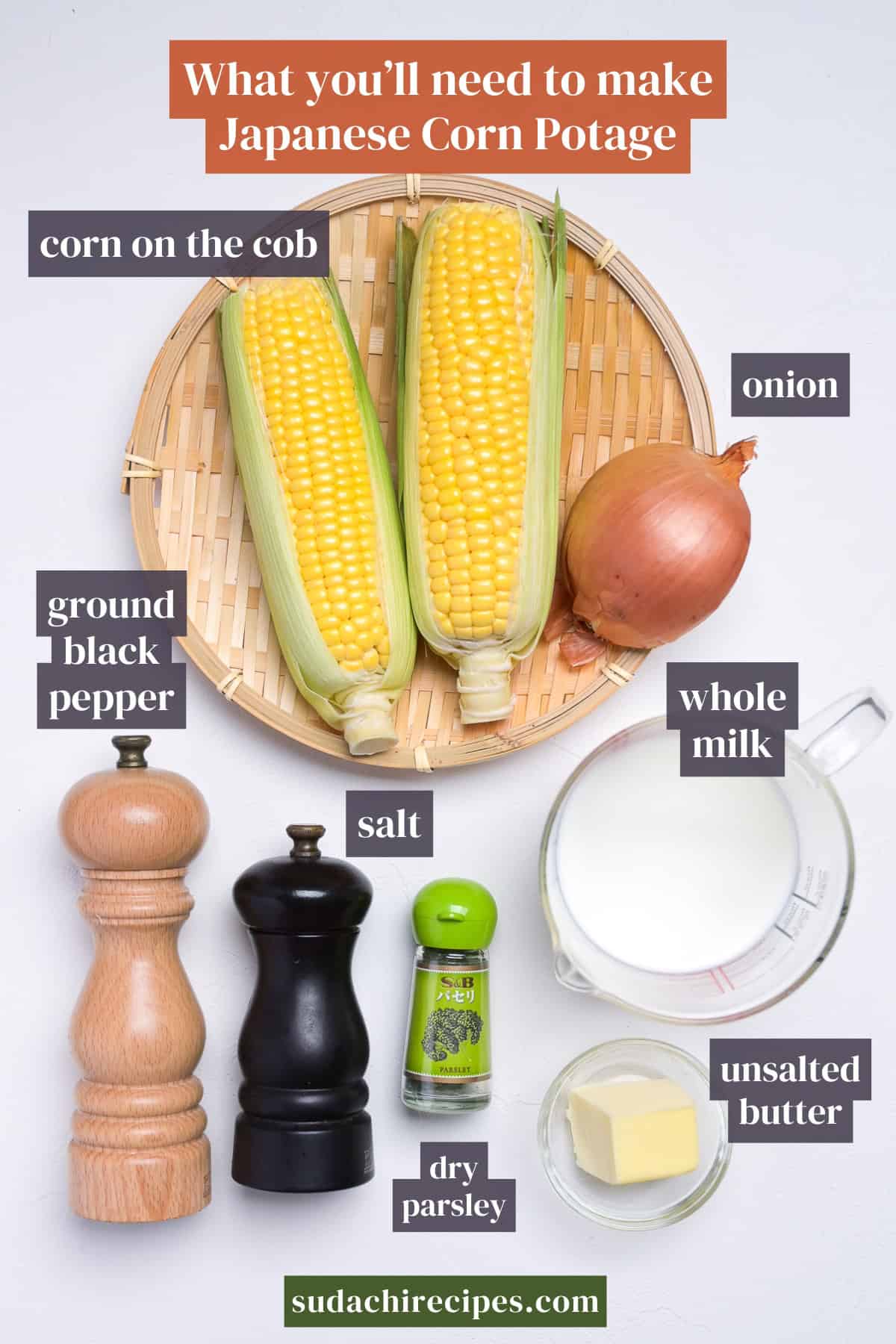 Ingredients needed to make Japanese corn potage on a white background with labels. From top to bottom, left to right: corn on the cob, onion, ground black pepper, salt, whole milk, dry parsley, unsalted butter.