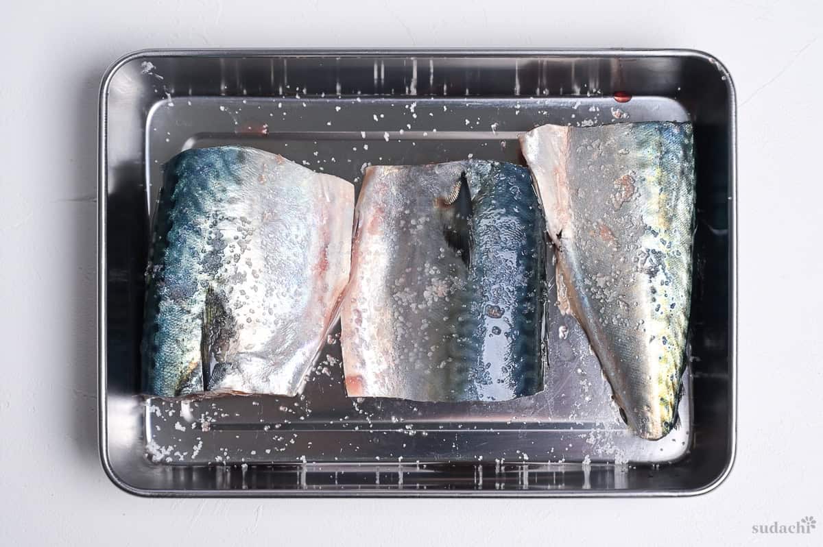 salted mackerel fillets in a metal container