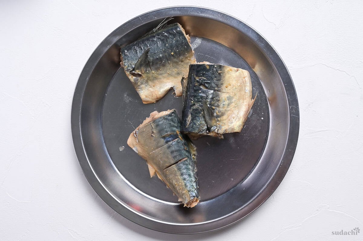 Simmered miso simmered mackerel fillets on a silver plate.