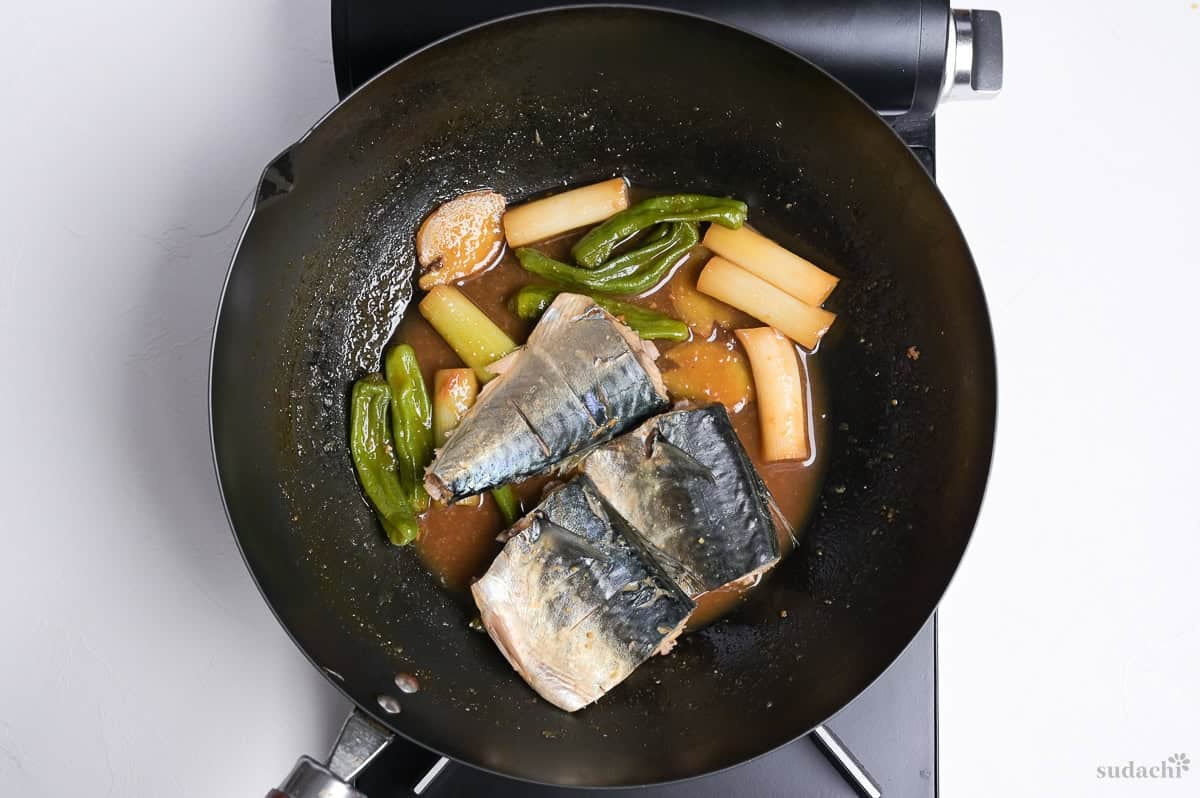 Mackerel fillets added back to the pan with broth to make miso simmered mackerel (saba no miso-ni)