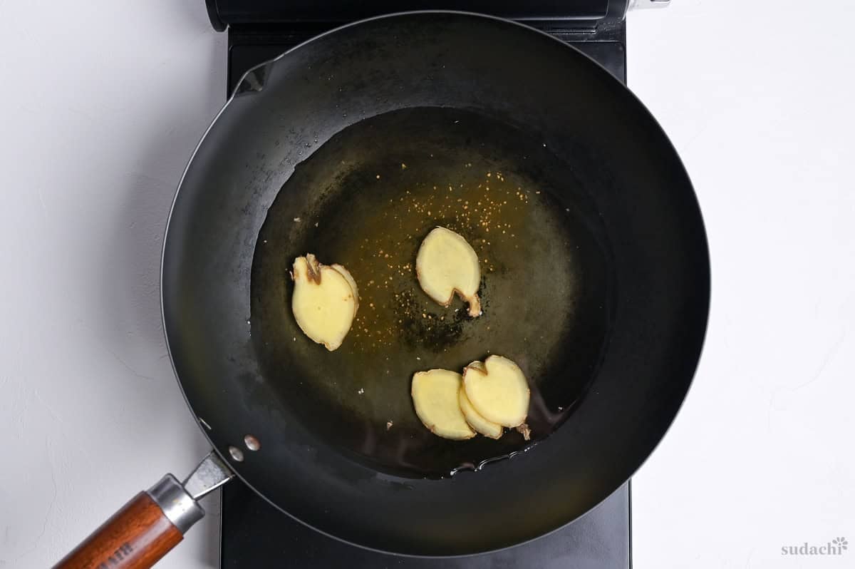 Sliced ginger root simmering in cooking liquid for Saba no Miso ni (Japanese miso simmered mackerel)