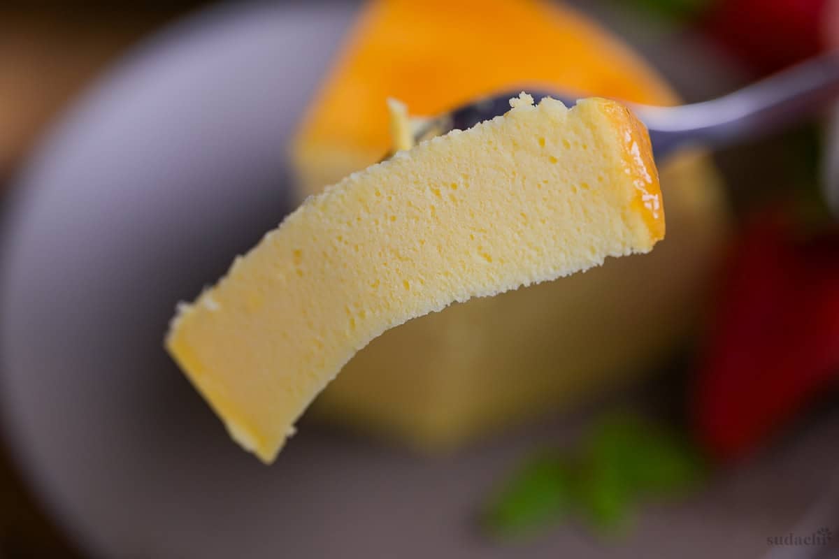 A close up of a piece of souffle cheesecake on a dessert fork
