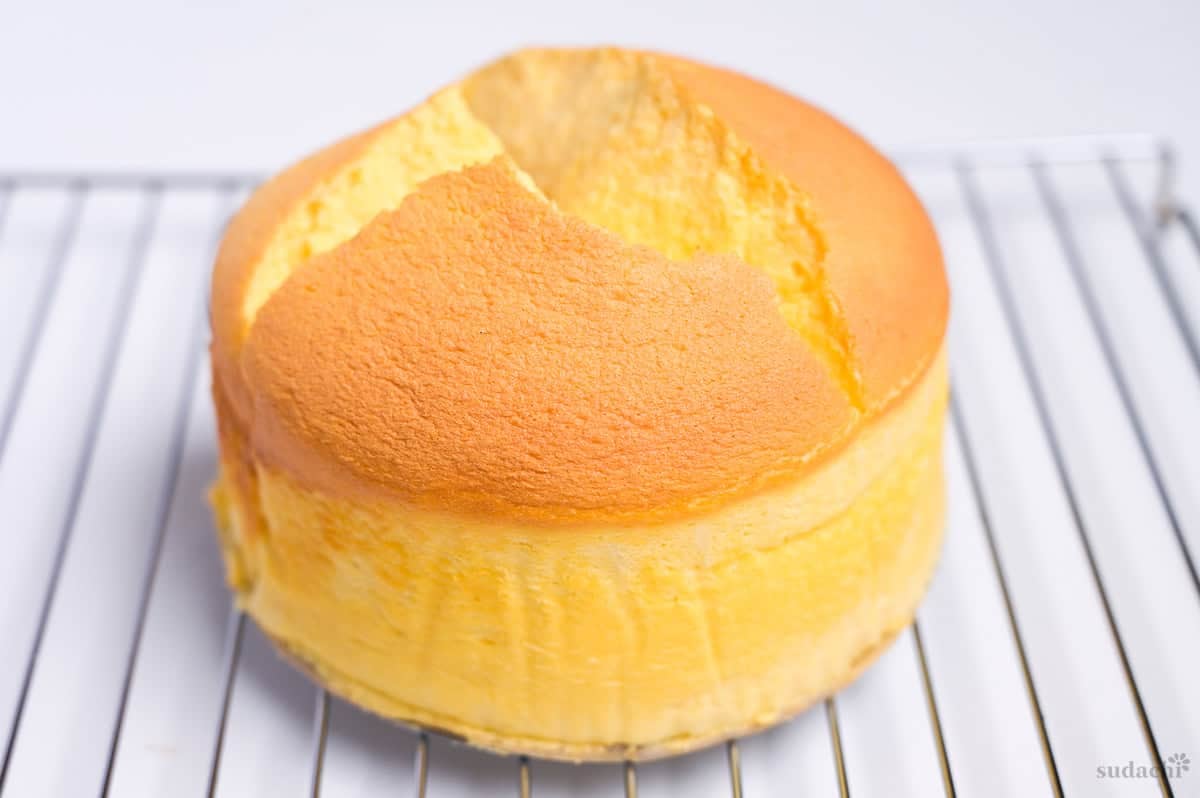 cracked Japanese souffle cheesecake on a wire rack