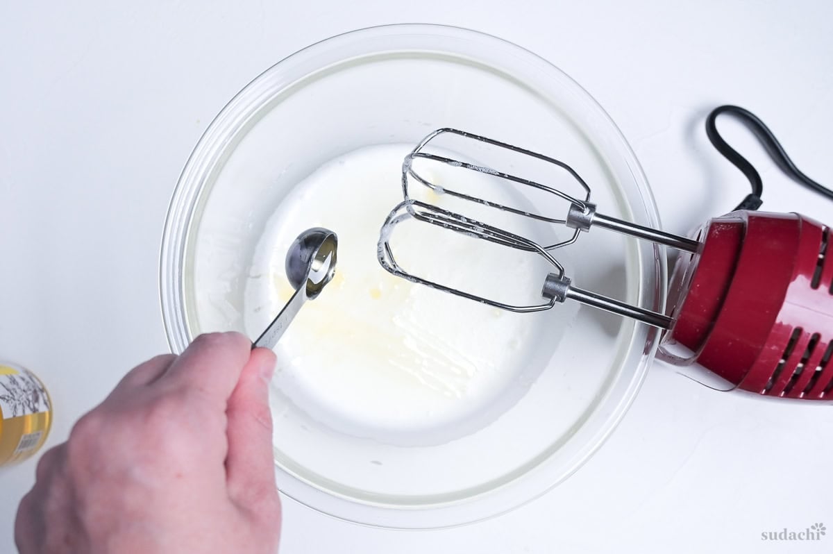 drizzling honey into meringue to make Japanese soufflé cheesecake