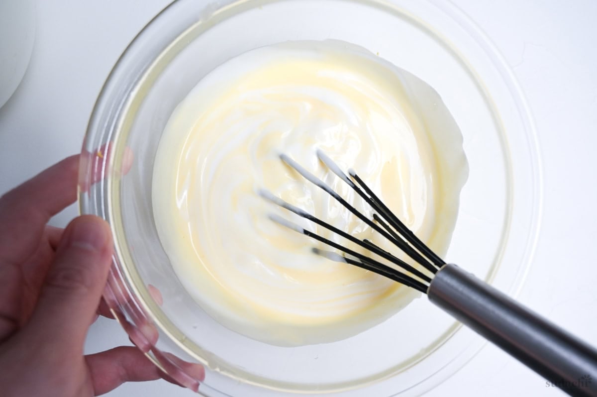 whisking meringue into soufflé cheesecake base
