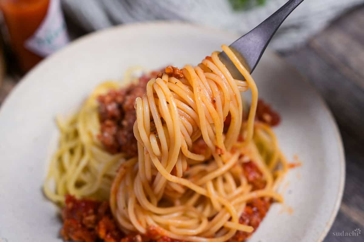 Close up of Japanese spaghetti meat sauce wrapped around a silver fork