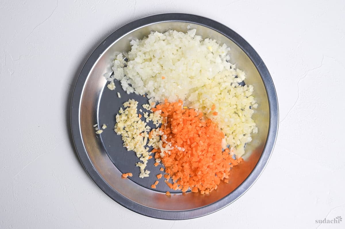 Finely diced onion, carrot, celery and garlic on a silver platter