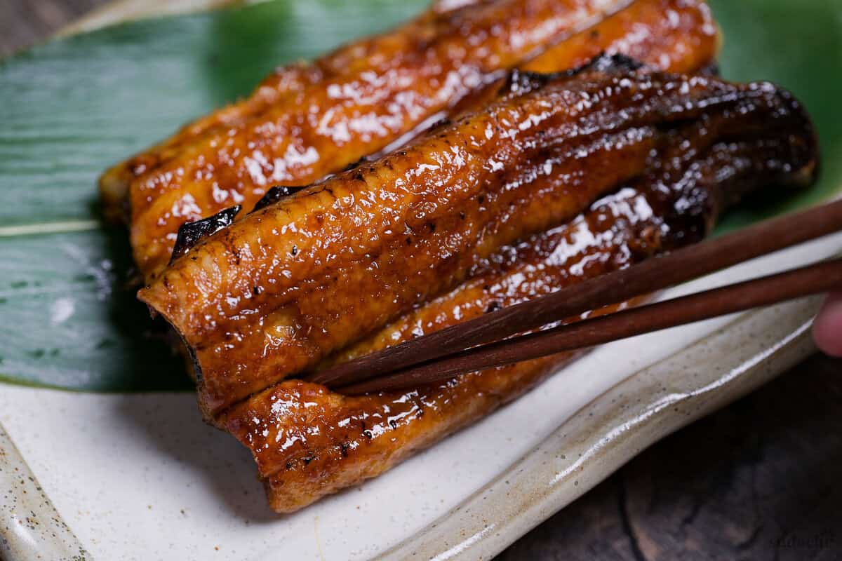 Wooden chopsticks breaking into homemade unagi kabayaki