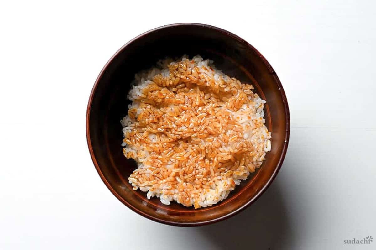 Rice brushed with unagi tare in a red donburi bowl