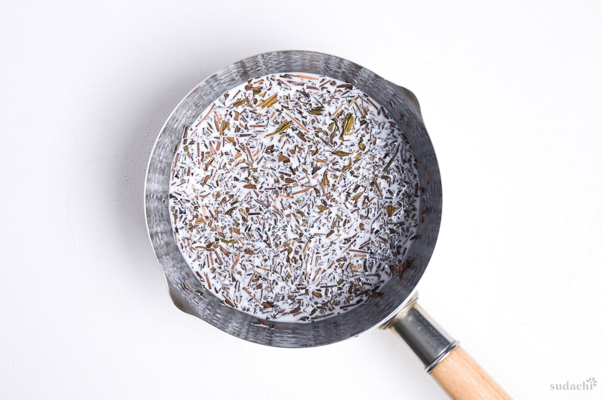 soaking loose hojicha tea in whole milk in a sauce pan