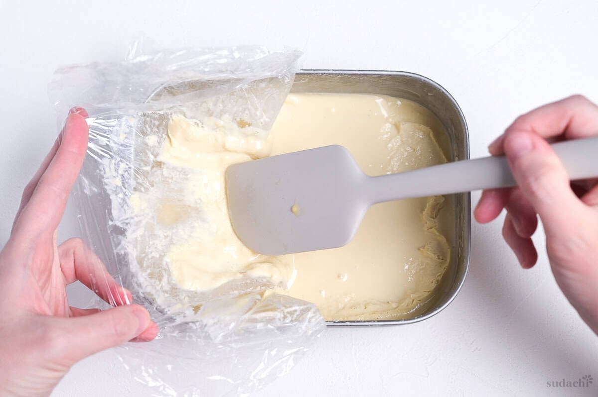 scraping hojicha ice cream off of plastic wrap during churning