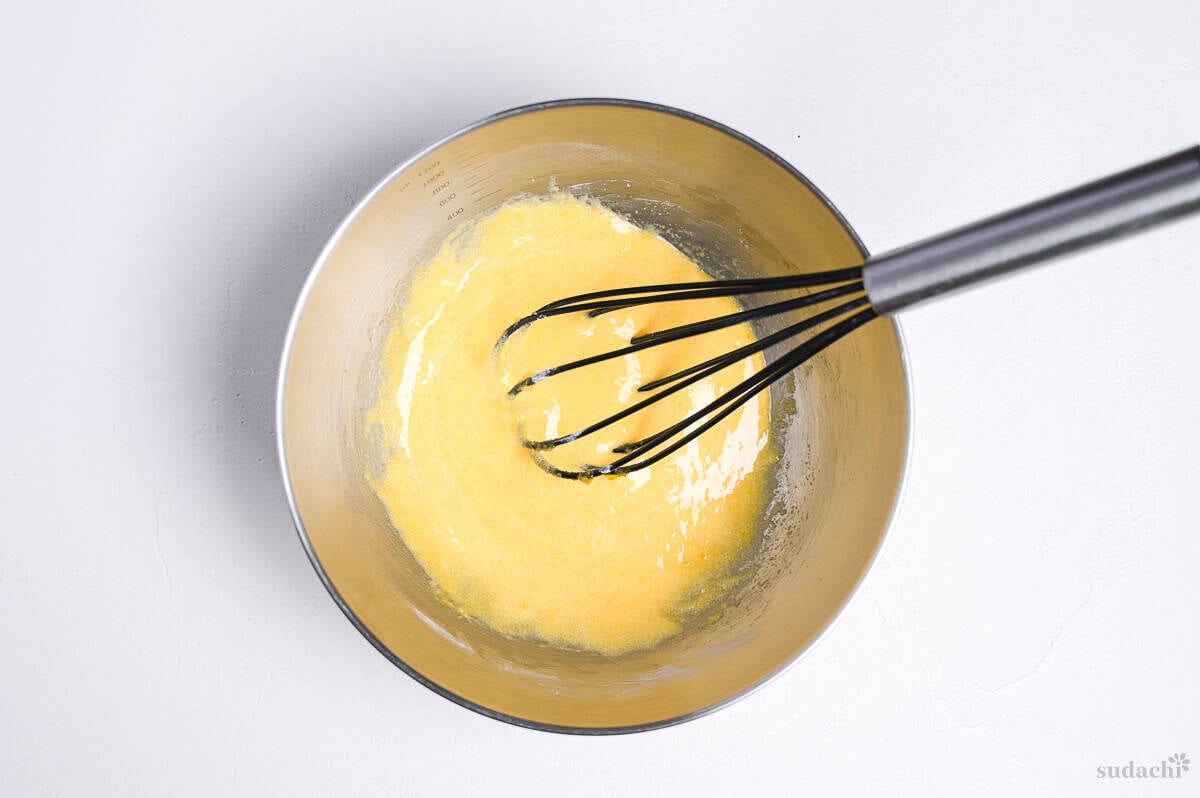 egg yolks whisked with sugar and starch in a steel mixing bowl