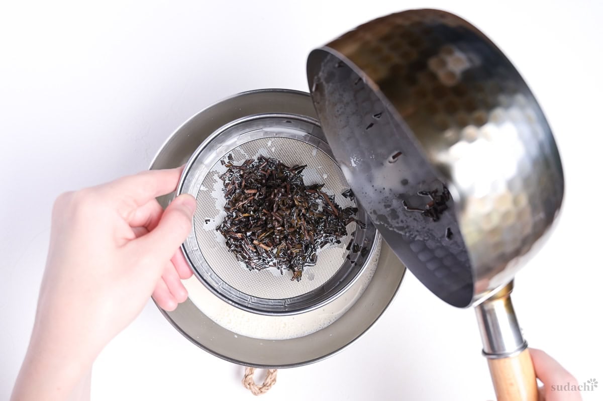 straining hojicha from milk and cream mixture