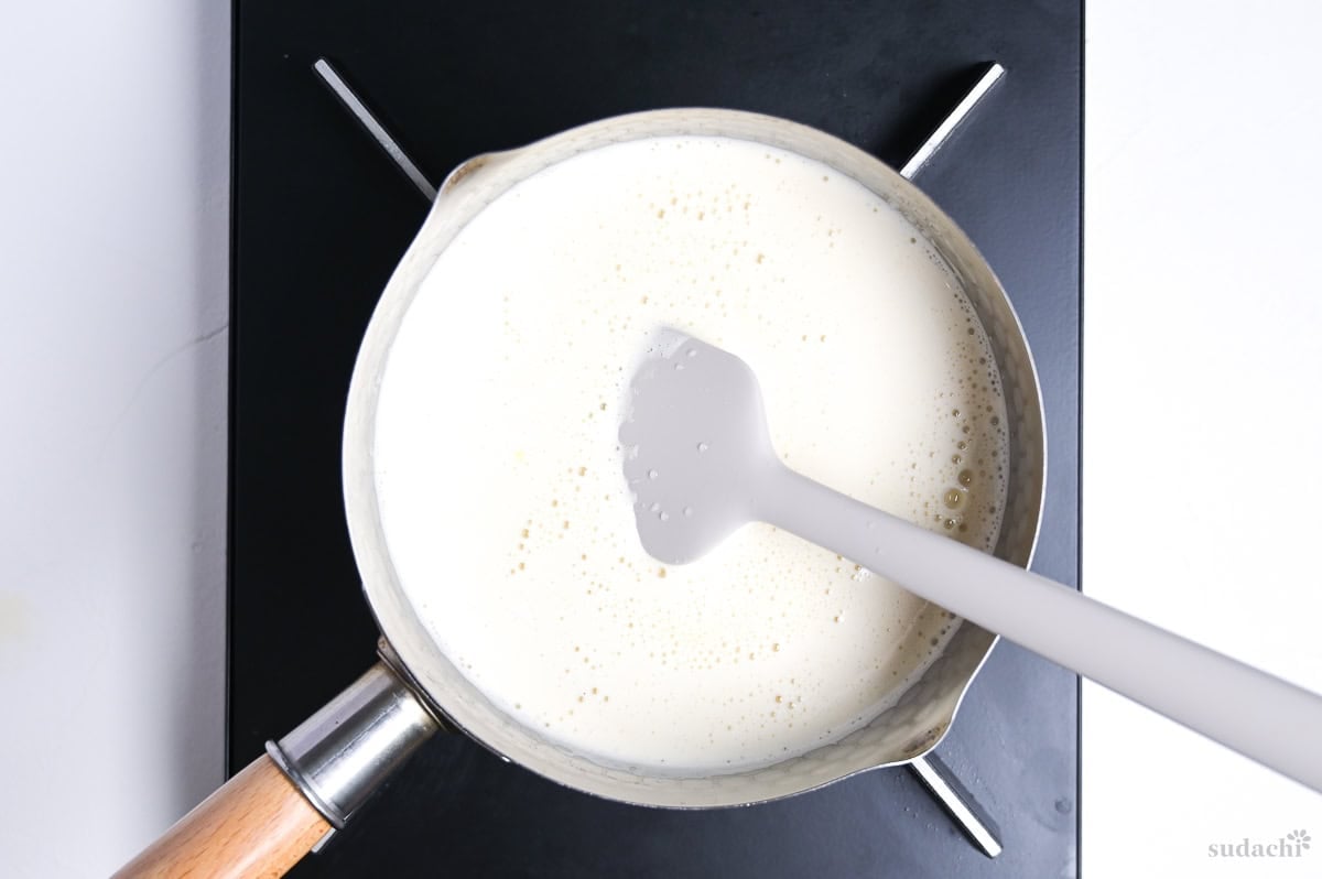 heating hojicha ice cream mixture in a saucepan on the stove top