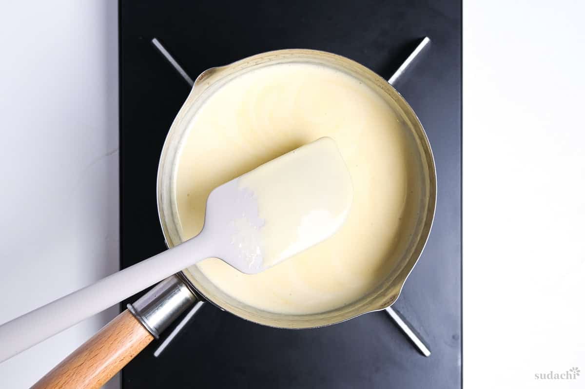thickened hojicha ice cream base in a sauce pan on the stove top