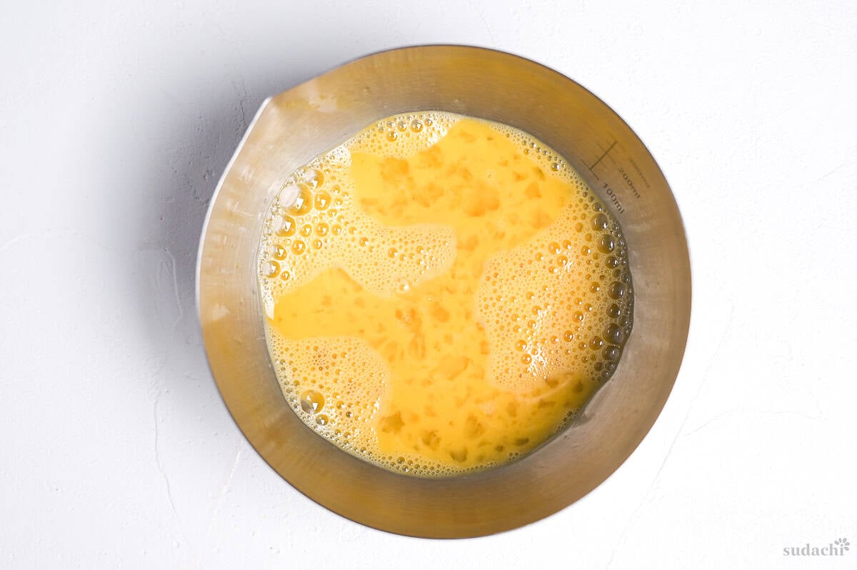whisked egg in a steel mixing bowl