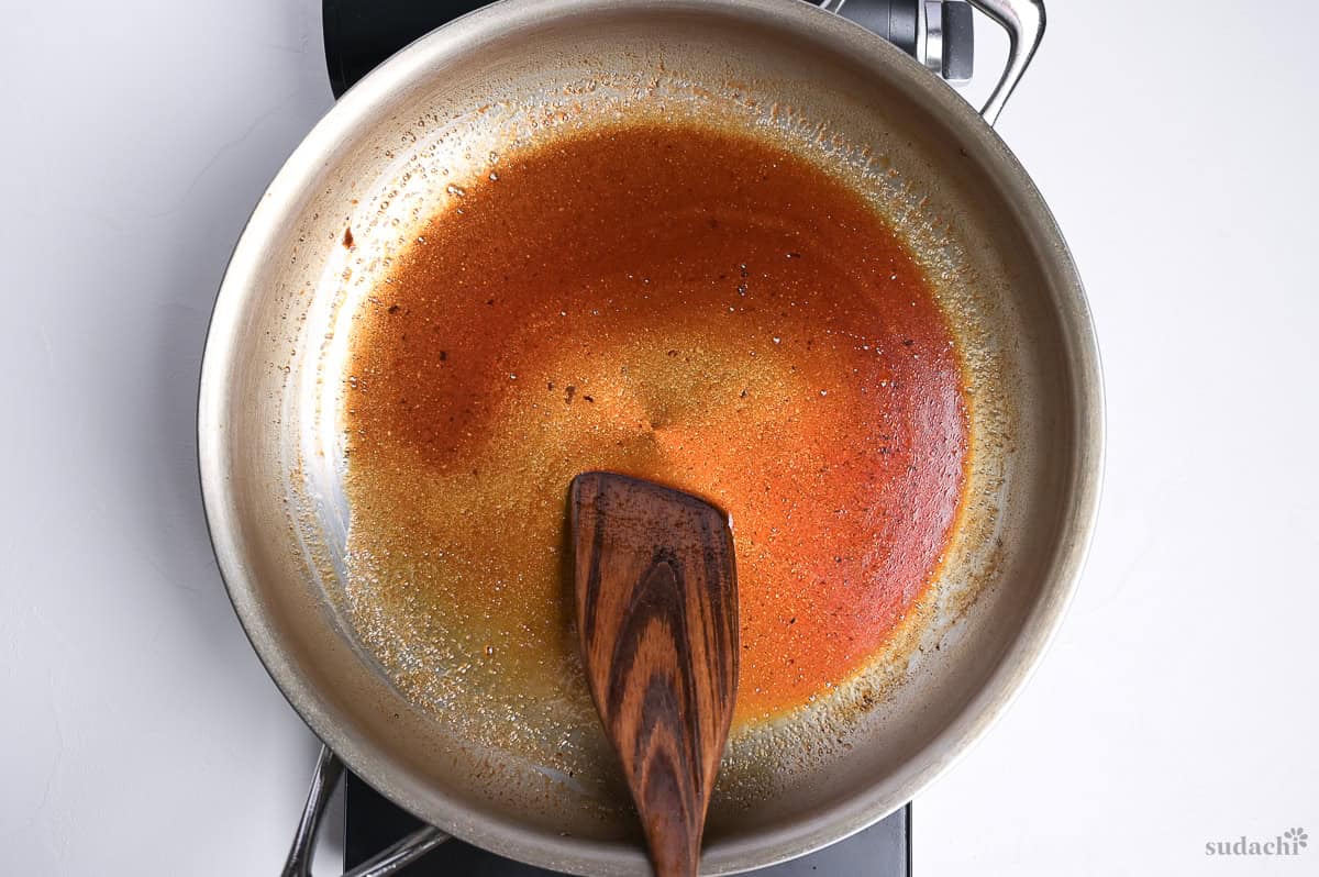 steak sauce for steak jyu reducing in a large pan on the stove top