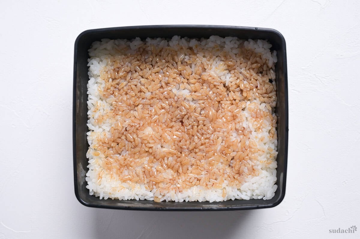 Cooked Japanese rice brushed with steak sauce in a jubako (Japanese serving box)
