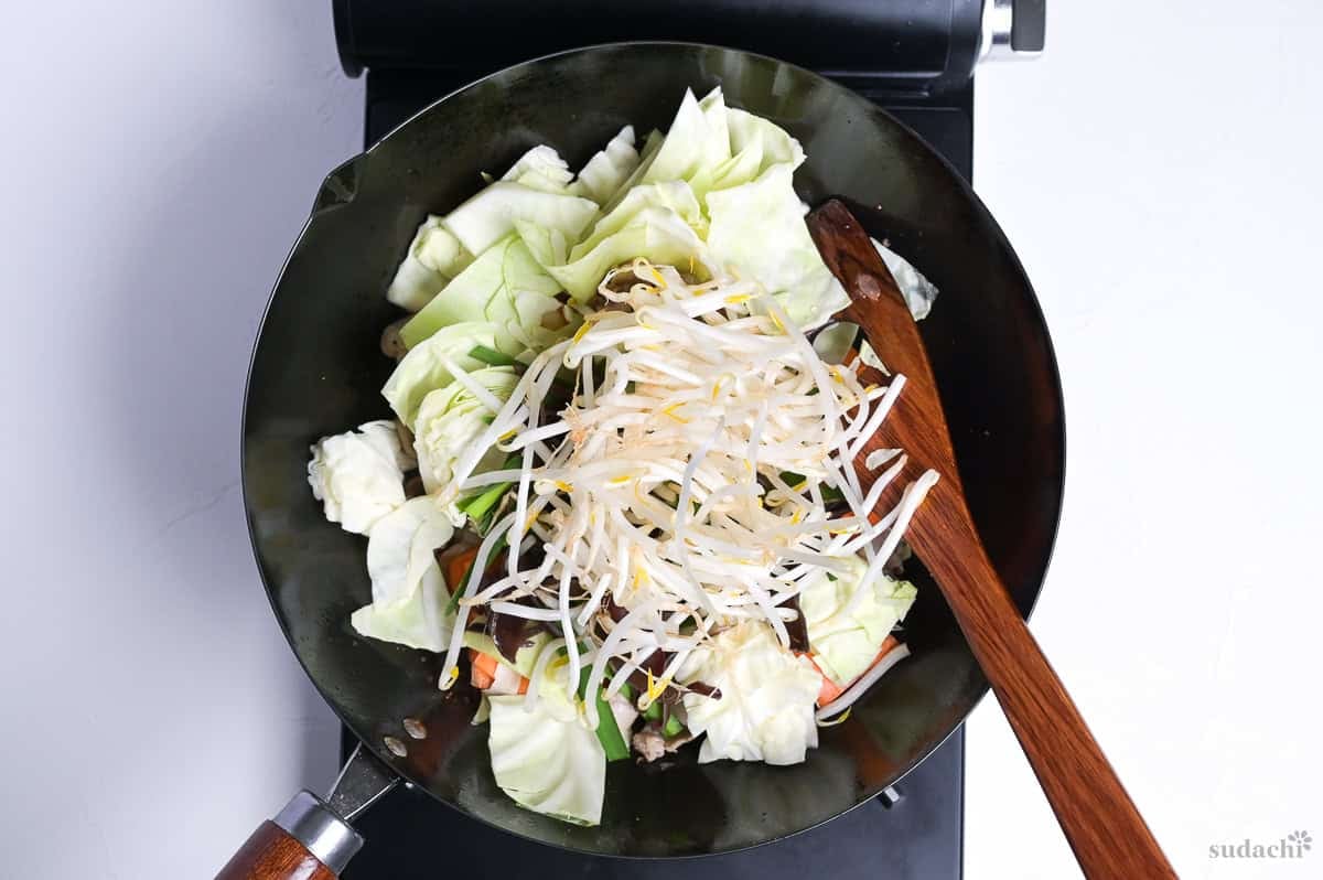 Vegetables for tanmen added to wok for stir frying.