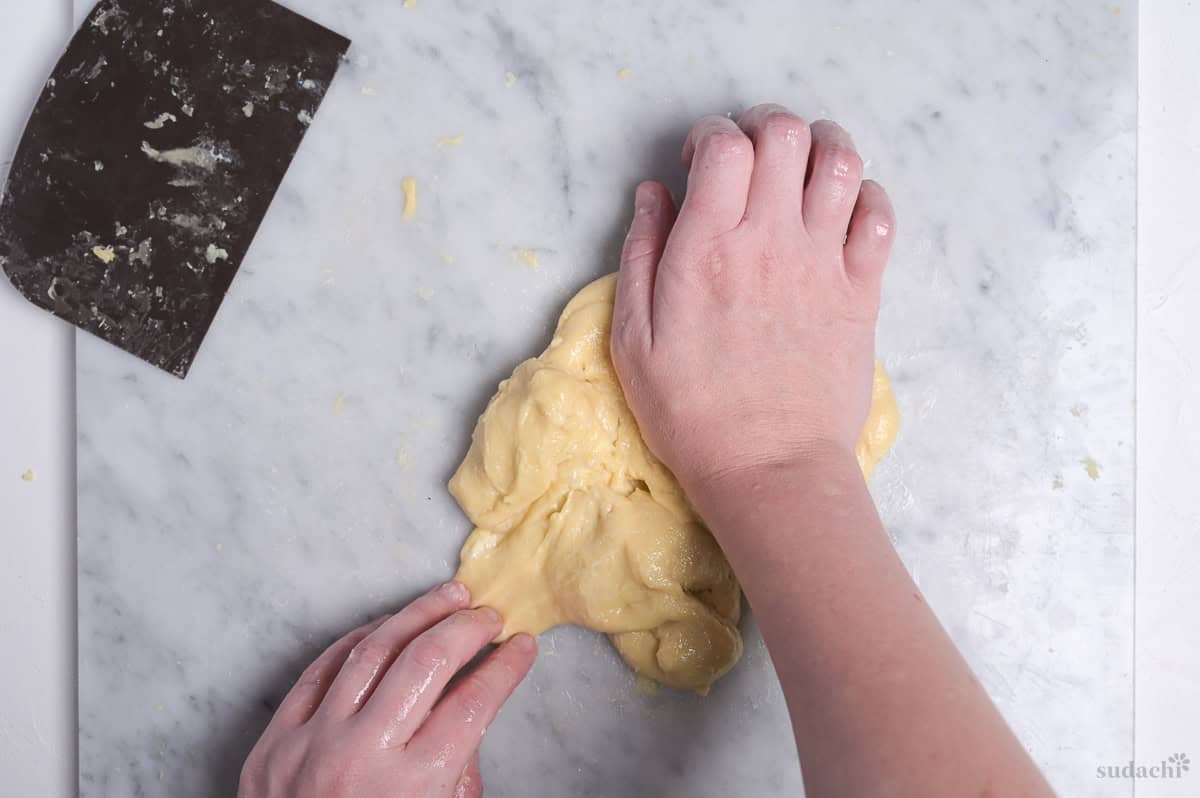 kneading butter into dough