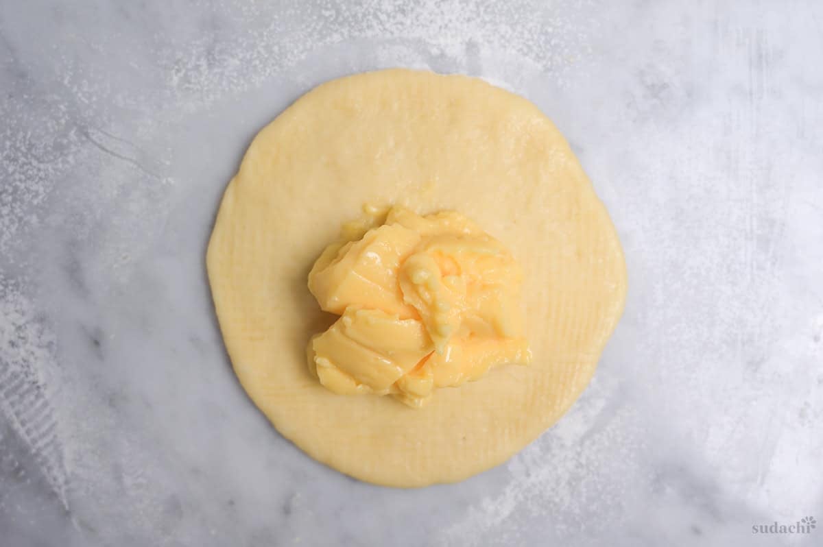 a portion of pastry cream on a rolled out dough