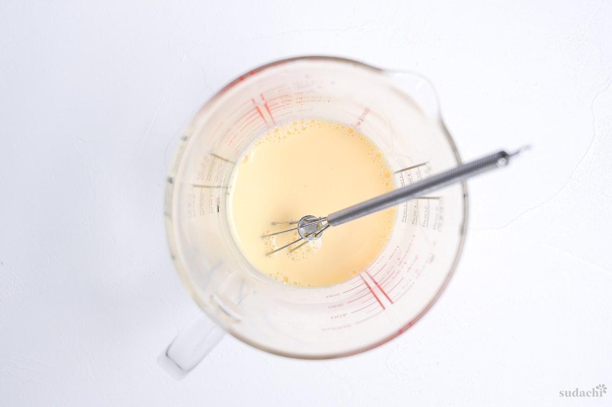 milk, water and egg whisked in a glass jug