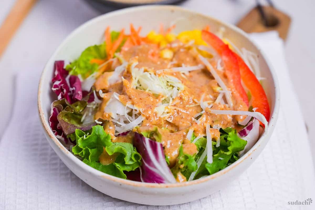 homemade Japanese goma sesame dressing drizzled generously over salad.