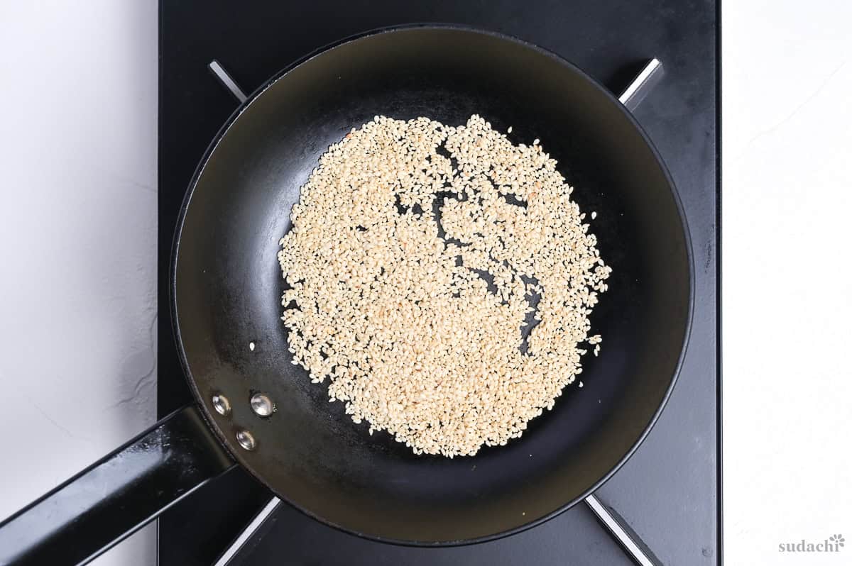 white sesame seeds in a pan on the stove top