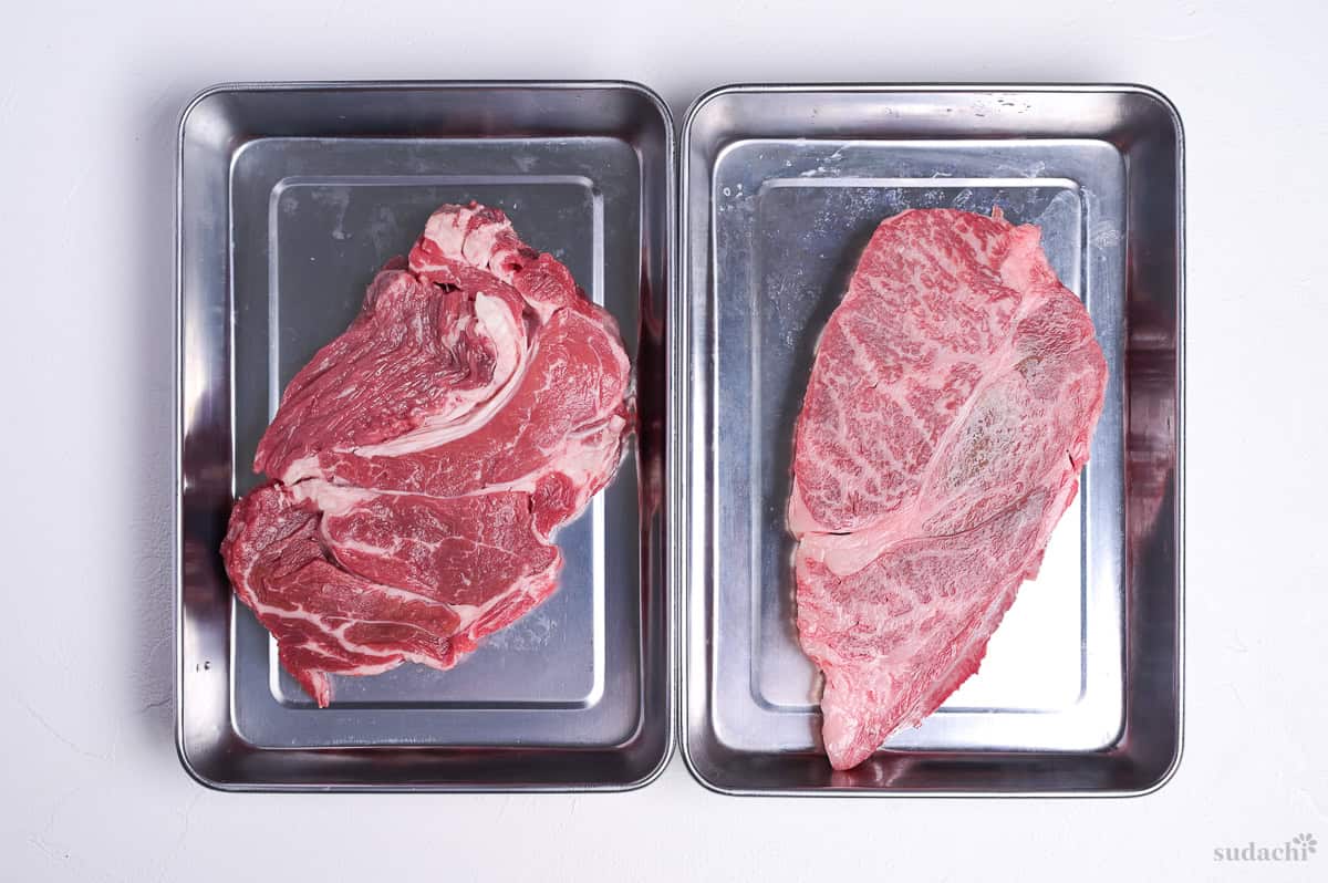 two beef steaks in separate steel containers