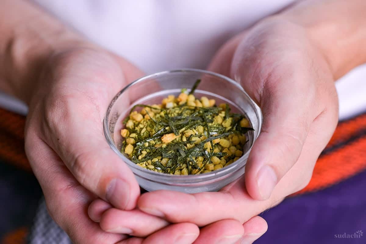 Yuto Omura holding up homemade instant ochazuke in a small glass bowl