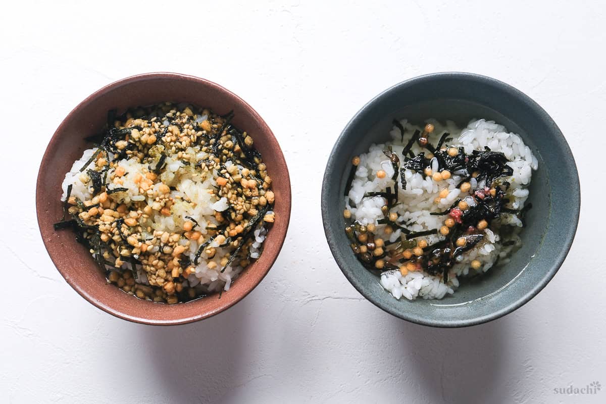 Homemade instant ochazuke and store bought side by side over rice topped with hot water