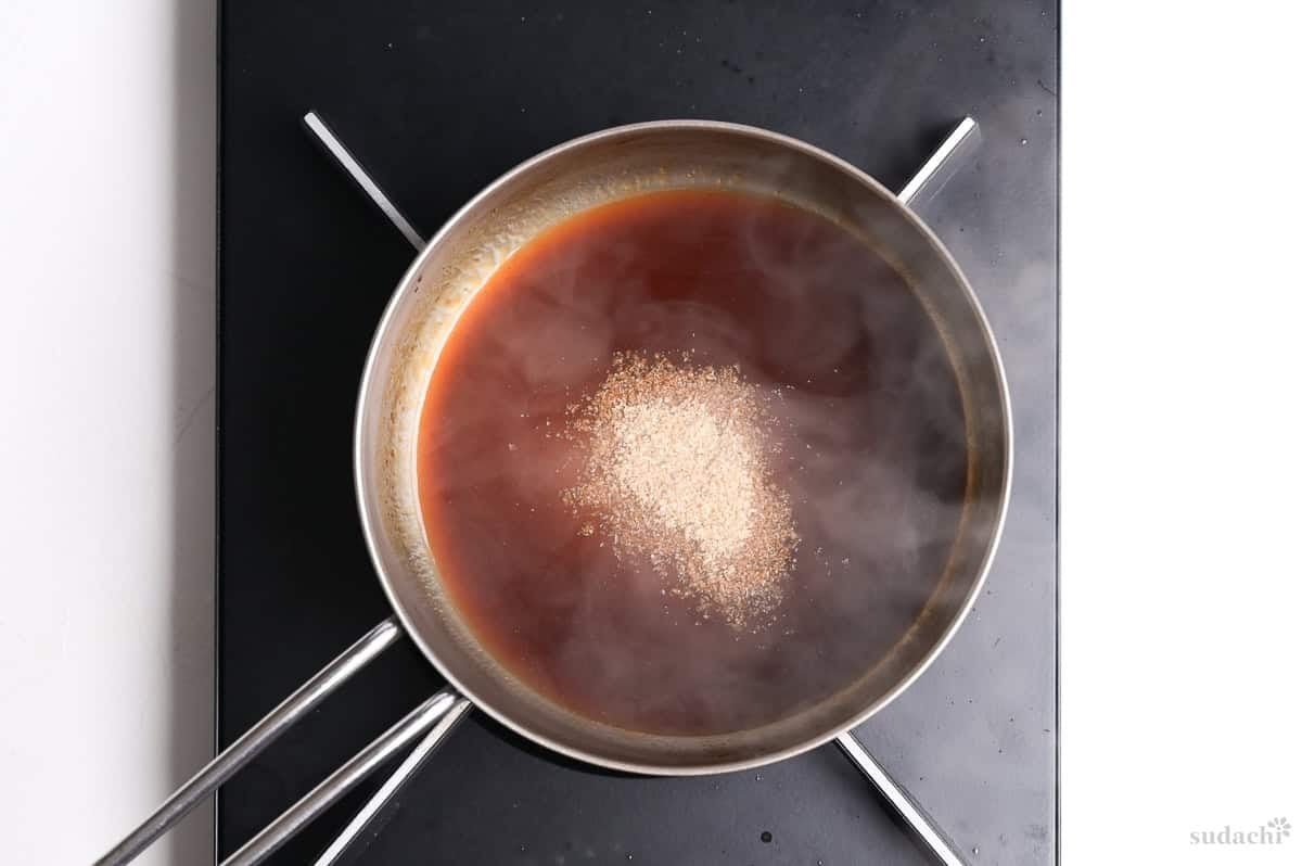 katsu sauce in a saucepan with ground sesame seeds added