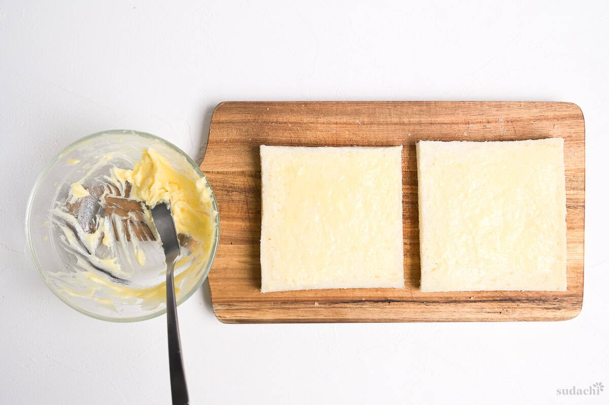 karashi butter spread over two pieces of bread
