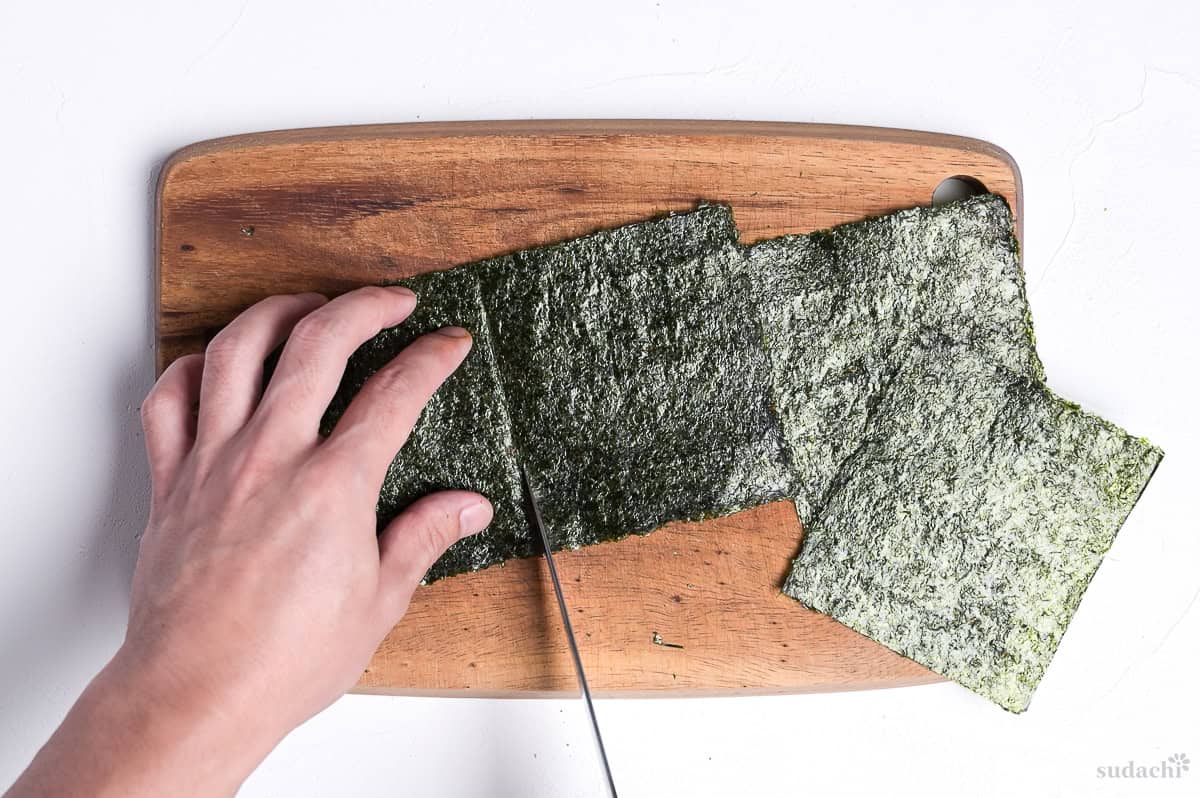 yaki nori sheet cut into four pieces on a wooden cutting board