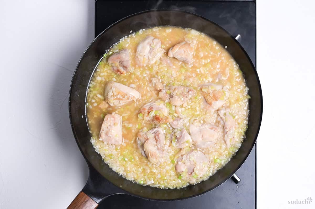 Broth and rice added to pan to make negi shio paella.