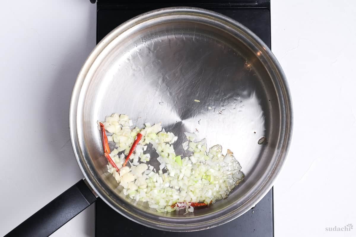 Finely diced negi (Japanese leek) and garlic, and deseeded chilis frying gently in a pan on the stove top