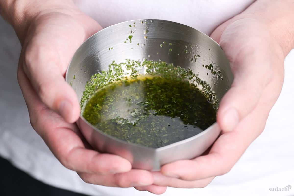 Yuto Omura holding a bowl of homemade shiso salad dressing