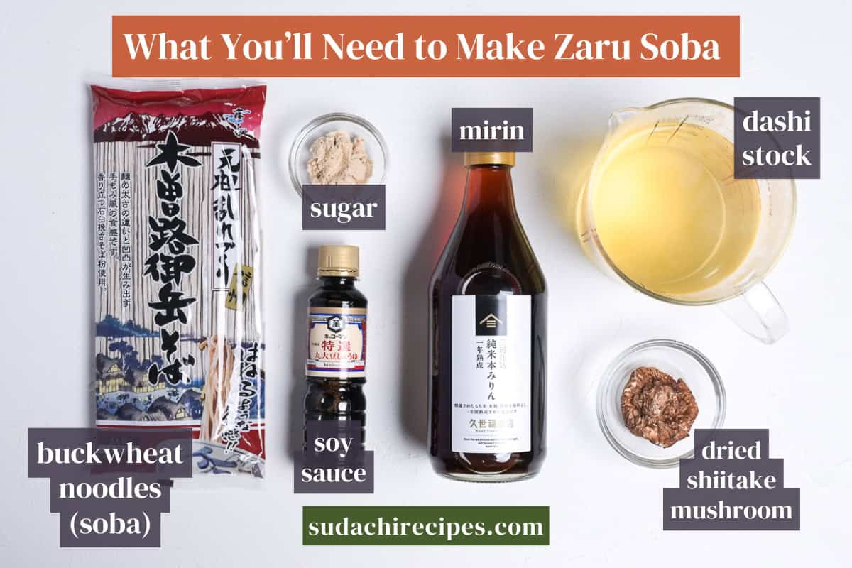 Ingredients needed to make zaru soba and homemade dipping sauce on a white background with labels. From left to right: buckwheat noodles (soba), sugar, soy sauce, mirin, dashi stock, dried shiitake mushrooms.
