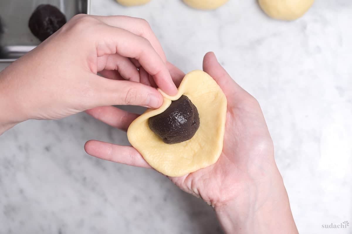pinching sweet dough around a ball of anko