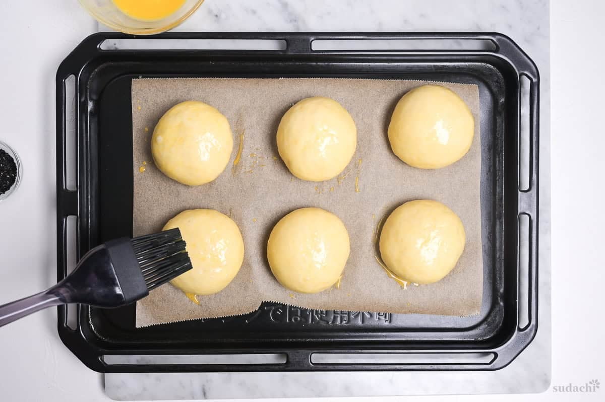brushing unbaked anpan with egg wash after second rise