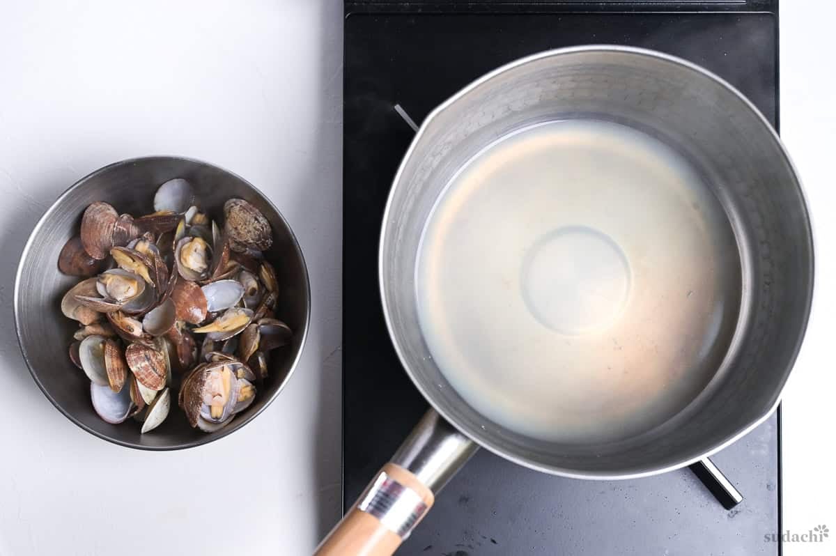 steamed clams removed from pan leaving clam stock