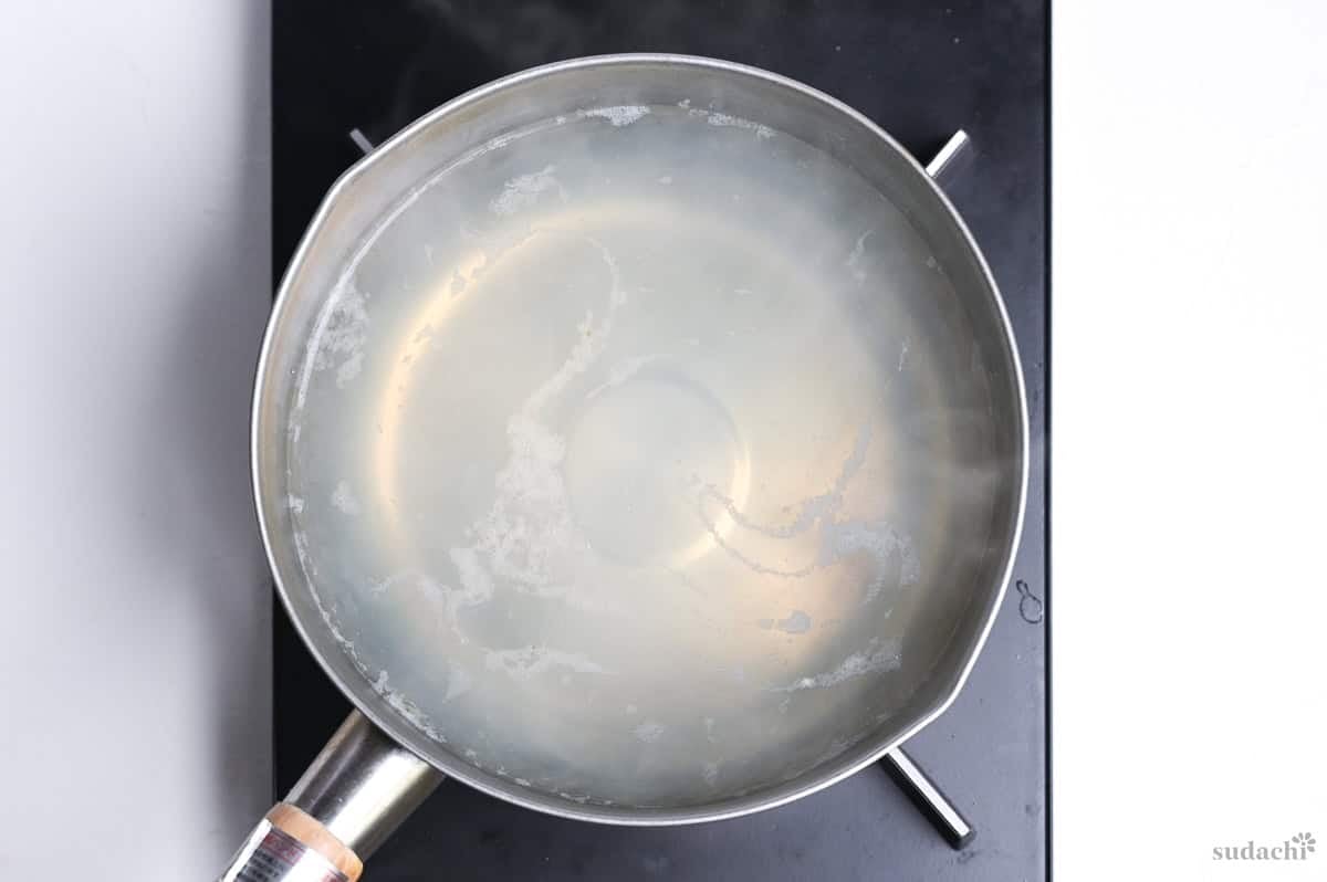 heated kombu and clam stock in a saucepan for asari miso soup