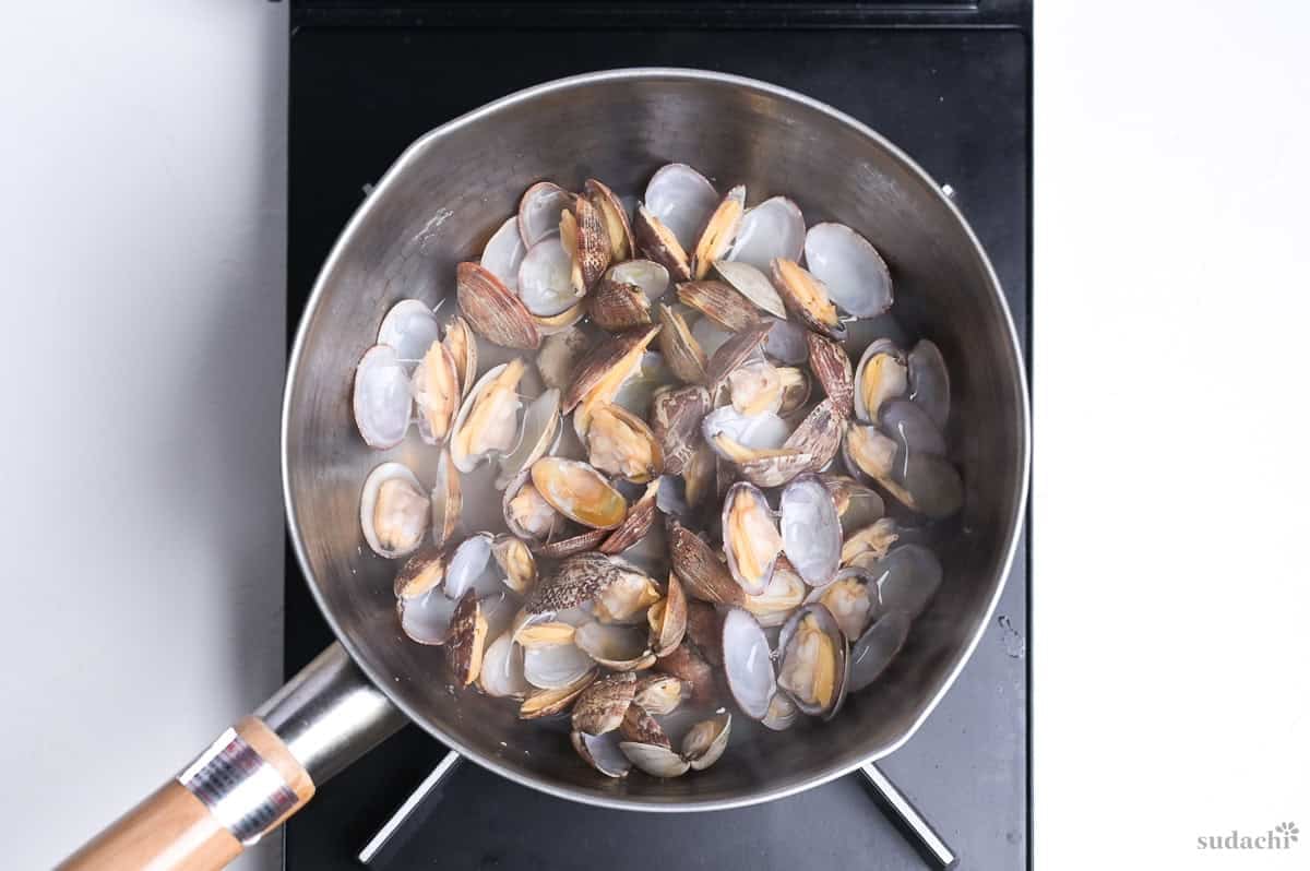 steamed manila clams in a saucepan on the stove top